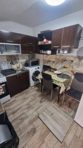 a small kitchen with a table and a stove at Casa AVA 2 Mai in 2 Mai