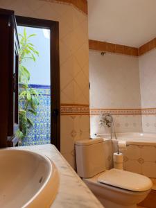 a bathroom with a sink and a toilet and a tub at Great House Almería in Almería +19 photos