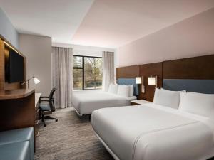 a hotel room with two beds and a television at EVEN Hotel Alpharetta - Avalon Area by IHG in Alpharetta +58 photos