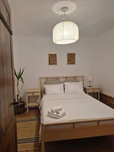 a bedroom with a bed with two towels on it at Casa LADIS in Iernut
