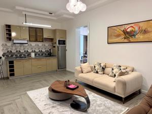 a living room with a couch and a table at ASFARO Apartments in Abuja