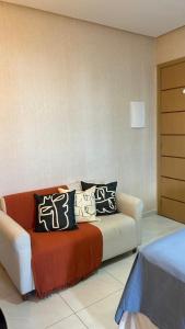 a living room with a couch with pillows on it at Studio premium aconchegante vista mar in São Luís +34 photos