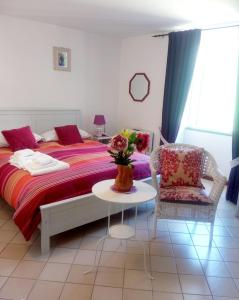 a bedroom with a bed with a table and a chair at Le Terrazze di Cristina in Vietri sul Mare