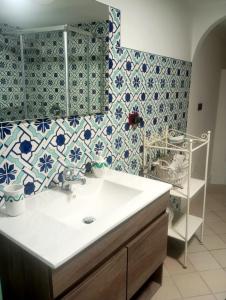 a bathroom with a sink and blue and white tiles at Le Terrazze di Cristina in Vietri sul Mare +79 photos