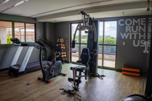 a gym with tread machines and a sign that reads come run with us at Studio premium aconchegante vista mar in São Luís