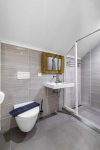 a bathroom with a toilet and a sink at Art Hotel in Kralendijk