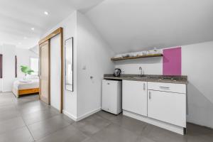 a kitchen with a sink and a counter top at Art Hotel in Kralendijk +31 photos
