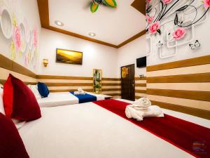 a bedroom with two beds with towels on them at K D Dham Hotel- Near Prem Mandir & Iskcon Temple Vrindavan in Vrindāvan