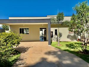 a house with a driveway in front of it at chácara 3A-2 in Pôrto Feliz