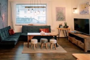 a living room with a couch and a table at Kunstwerk AppARTement in Sankt Michael im Lungau