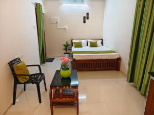 a small room with a bed and a table at Krishna Theeram 150m from Temple in Guruvāyūr