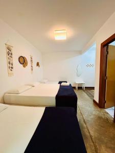 a bedroom with a large bed and a table at Pousada Casa de Inaê in Itacaré