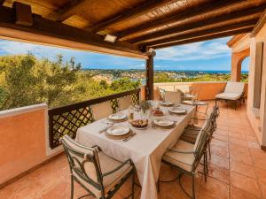 a table and chairs on a balcony with a view at Porto Cervo Marina Three-Bedroom House with Pool in Porto Cervo
