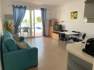 a living room with a blue couch and a table at Casa Elite in Calpe