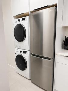 two washers and a refrigerator in a kitchen at Modern Vancouver 2BR Suite Full Kitchen & Laundry in Vancouver