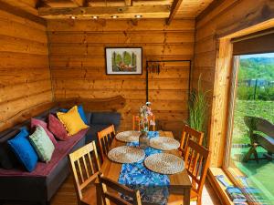 a wooden room with a table and a couch at Chaty Jak Dawniej 787-330-207 in Wołkowyja
