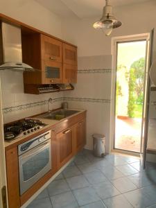 a kitchen with a sink and a stove at Villa 4 Rose in Sant'Angelo D'Ischia