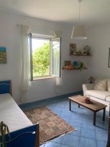 a living room with a couch and a table at Villa 4 Rose in Sant'Angelo D'Ischia +12 photos