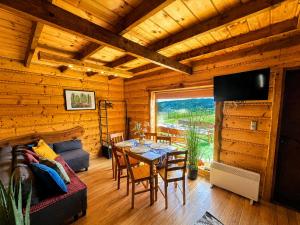 a living room with a table and a couch at Chaty Jak Dawniej 787-330-207 in Wołkowyja
