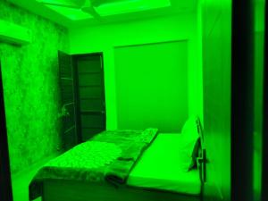 a green bedroom with a bed with a green room at Villa Elysian Park-1483 in Lāndrān