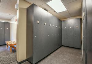 a locker room with gray lockers and a bench at Red Hawk Lodge 2269 by SummitCove Lodging in Colorado in Keystone