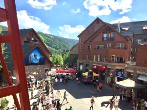 a group of people walking around a market in a town at Red Hawk Lodge 2269 by SummitCove Lodging in Colorado in Keystone