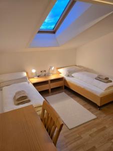 a attic bedroom with two beds and a skylight at Ferienwohnung Felder in Bürs