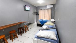 a hospital room with three beds and a bar at Recanto dos Pássaros 306C Até 10x Sem Juros no Cartão Direto com a Propriedade in Itapema +2 photos