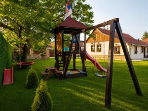 a playground in a yard with a swing at Salaš 1860 - Palić in Palić