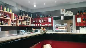 a bar in a restaurant with a counter with alcohol at Hotel Xibana in Tribano