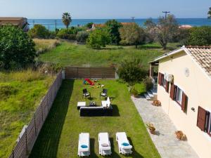 an aerial view of a backyard with chairs and tables at Villa Marietta in Agios Gordios +33 photos