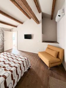 a bedroom with a bed and a couch at Ancona design apartment in Ancona