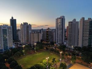 a city skyline with tall buildings and a park at Hotel Plaza Belmar by HCC in Campo Grande