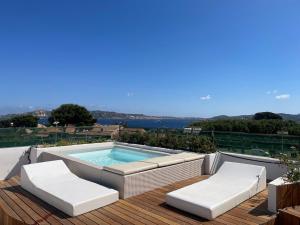 a swimming pool on a deck with two lounge chairs at Like at Home - Boutique A6 Sea view, Private Terrace & Pool in Palau +41 photos