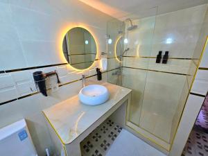 a bathroom with a sink and a shower with a mirror at Riad Boutique Baba in Rabat +61 photos