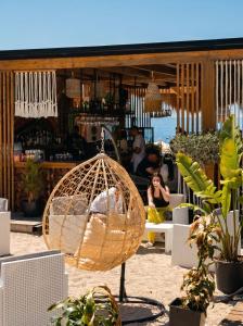 a bird cage sitting in front of a store at Don Mare in Dhërmi