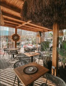 an outdoor patio with tables and chairs and a table and chairs at Don Mare in Dhërmi