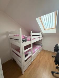 a white bunk bed in a room with a skylight at Apartman Maja in Prijedor +5 photos