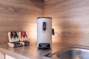 a coffee maker sitting on a counter next to a sink at Eifel Quartier im Herzen von Mendig in Mendig