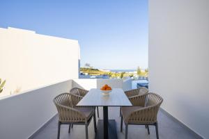 a dining room with a table and chairs at Maiandros Suites in Karterados