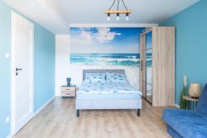 a bedroom with a bed and the ocean at Nadmorski Bursztyn - Błękitna in Rowy