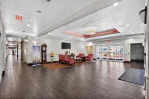 an empty lobby with a table and chairs at Sonesta Essential Hotel Houston-I-45 Spring in Houston