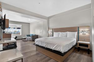 a bedroom with a bed and a living room at Sonesta Essential Hotel Houston-I-45 Spring in Houston