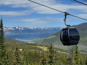 a gondola ride in a ski lift in the mountains at Quicksilver 1605 by SummitCove Lodging in Colorado in Keystone