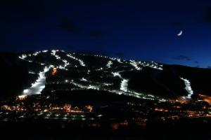 a night view of a mountain with lights on it at Quicksilver 1605 by SummitCove Lodging in Colorado in Keystone