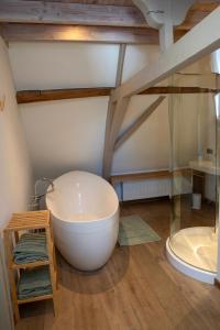 a bathroom with a large white bath tub in a room at Vakantiehuis Lisette in Veurne +36 photos