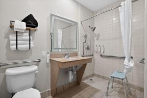 a bathroom with a toilet and a sink and a shower at Sonesta Essential Hotel Houston-I-45 Spring in Houston +24 photos