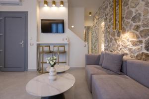 a living room with a couch and a table at Maiandros Suites in Karterados