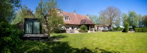 a house with a large yard with a tree at Vakantiehuis Lisette in Veurne