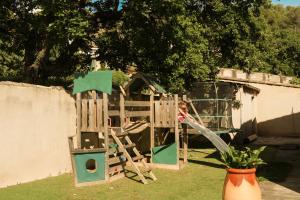 a child is playing on a wooden playground at Casa Mamou in Cavaillon